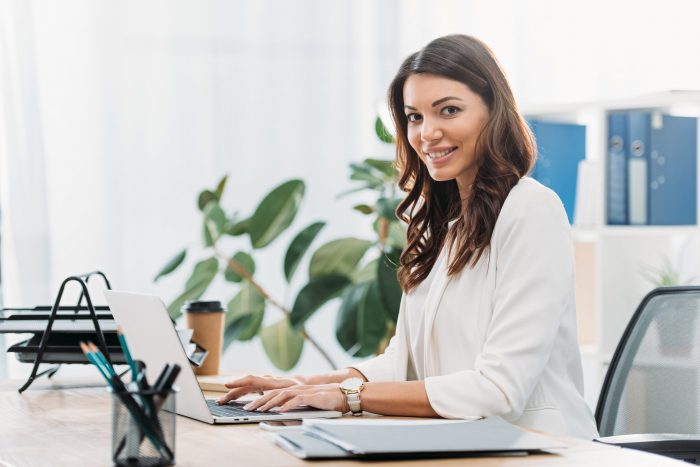 Working Mom smiling woman holding her laptop