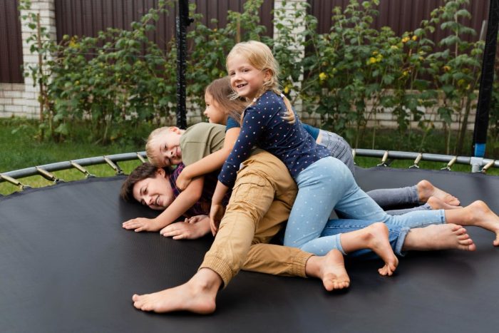 woman-kids-trampoline-min